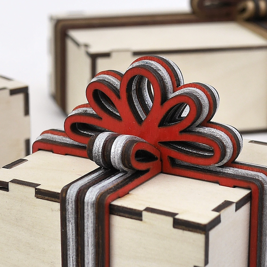 Gift boxes with layered wooden bowknot and ribbons
Lasercut vector model / project plan for laser cutting.